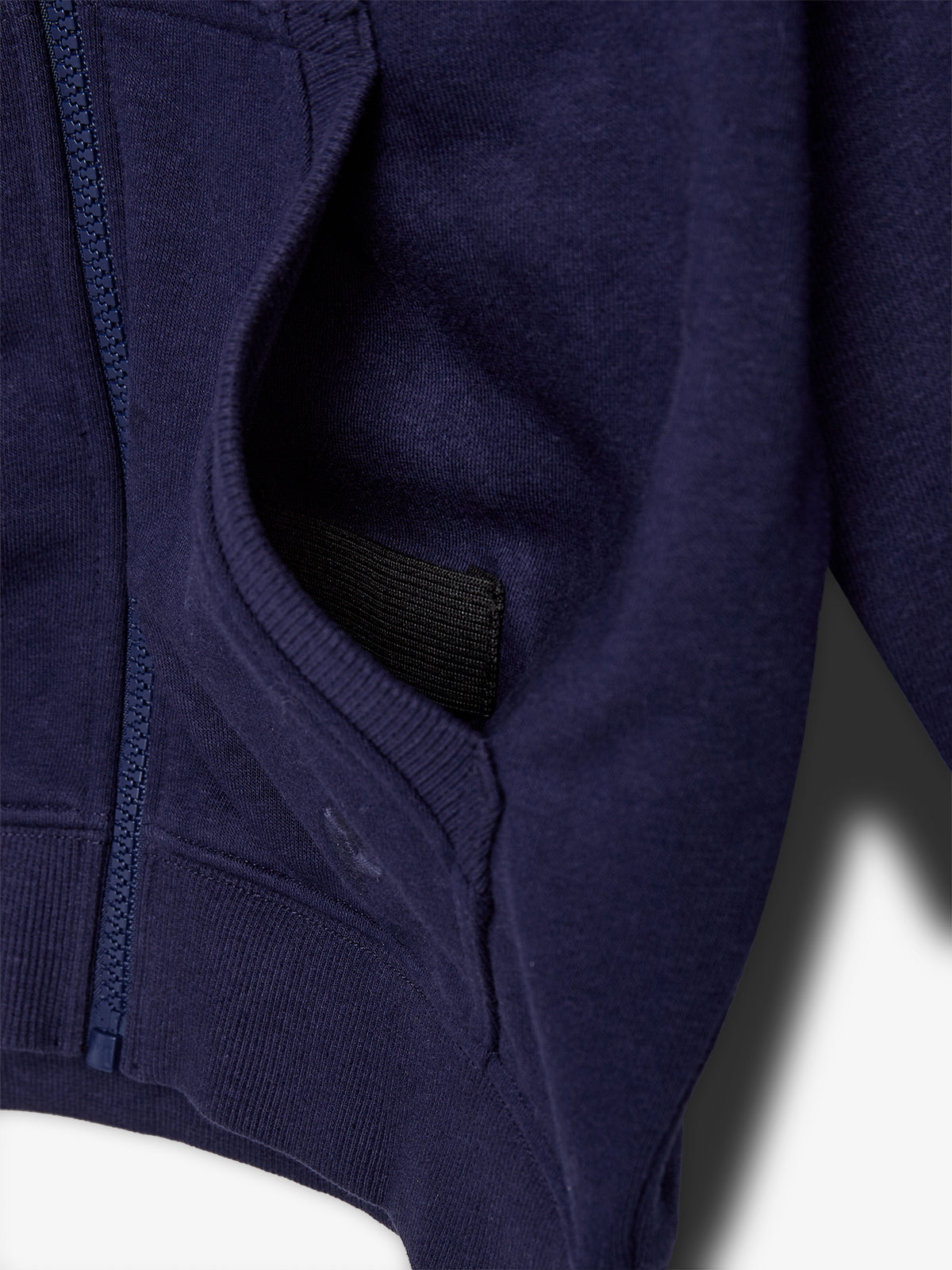 A navy blue hooded sweatshirt, partially unzipped, reveals a black interior lining, positioned against a plain white background.