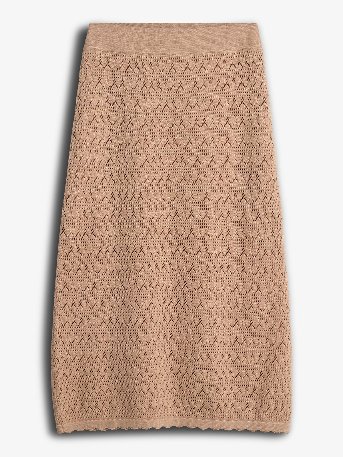 A beige, knee-length skirt with a zigzag knit pattern is placed against a plain white background, highlighting its textured design and scalloped hem.