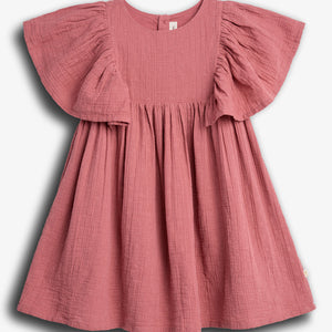 A pink, short-sleeved, textured dress hangs against a plain white background. The dress features ruffled sleeves and a gathered waist, creating a flowy silhouette.
