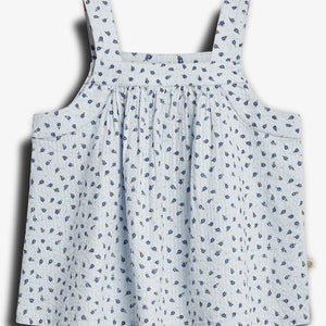 A light blue sleeveless top with thin straps, adorned with a pattern of small blue flowers, displayed against a plain white background.