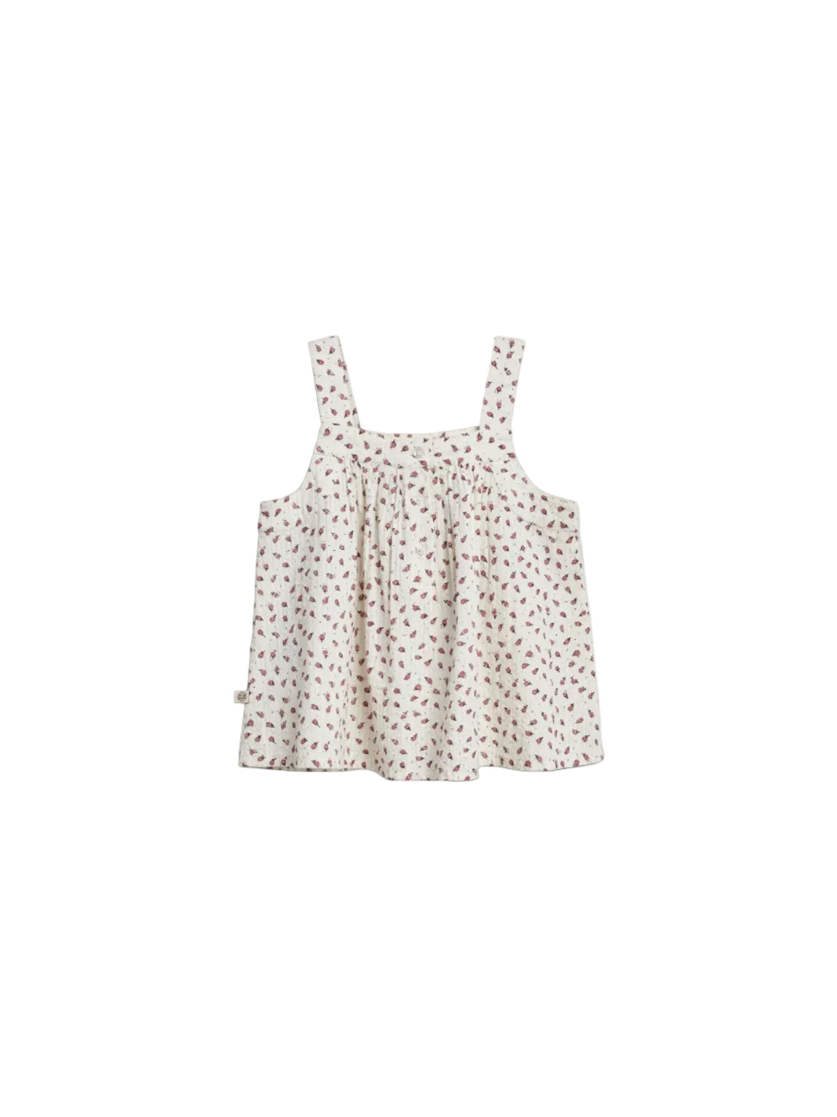 A sleeveless, white, floral-patterned blouse with shoulder straps is displayed on a plain white background. The blouse features small red flowers and a gathered, flowing design.