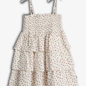 A floral-patterned, tiered dress with tied shoulder straps, featuring shirred bodice and layered ruffle skirt, displayed against a plain white background.