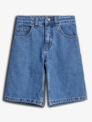 Jeansshorts in hellem Blau hängen flach. Sie haben einen Knopf- und Reißverschluss, Gürtelschlaufen und fünf Taschen. Der Hintergrund ist schlicht und neutral, was den Fokus auf die Shorts lenkt.