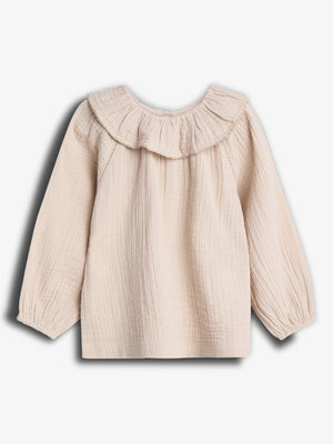 A cream-colored, long-sleeve blouse with a ruffled neckline is displayed from the back against a plain white background. The fabric appears textured and lightweight.