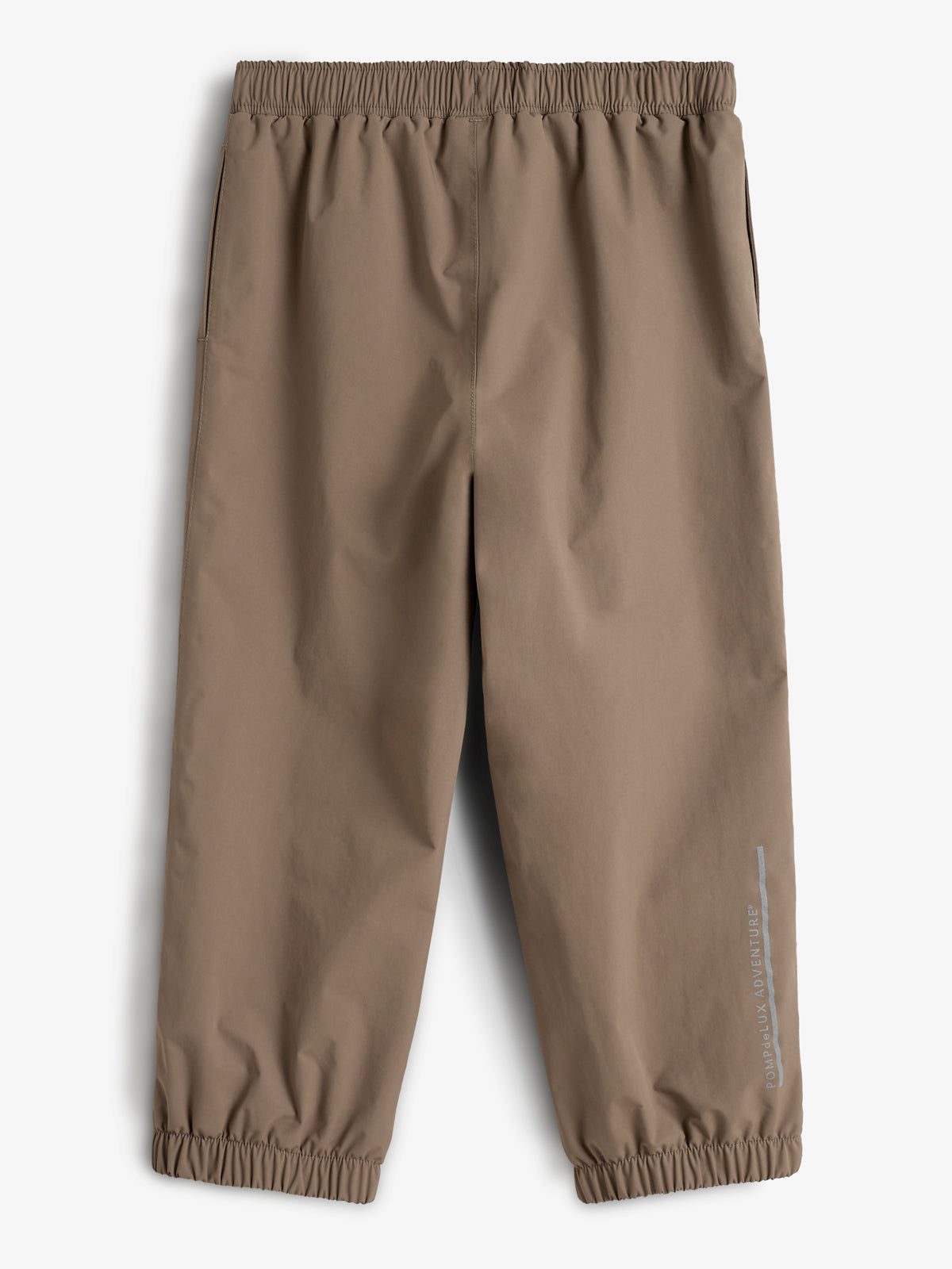 Beige Hose mit elastischem Bund und Beinabschlüssen. Im rechten unteren Bereich steht der Text "POWDERFLEX ADVENTURE". Der Hintergrund ist neutral gehalten.