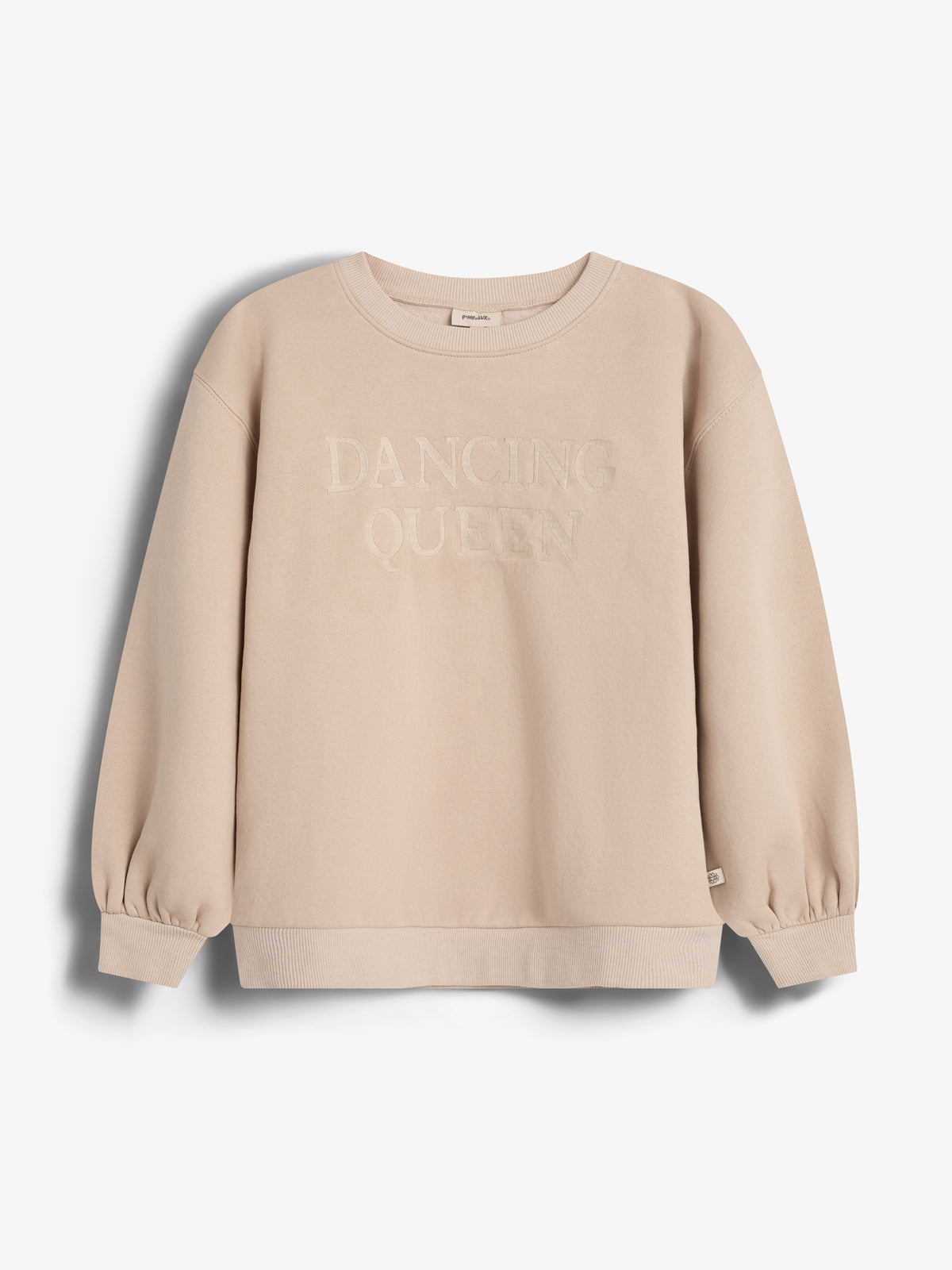 Ein beige Sweatshirt mit der Aufschrift "DANCING QUEEN" in der Mitte, hängt in einem neutralen, weißen Raum. Das Sweatshirt hat lange Ärmel und gerippte Bündchen.